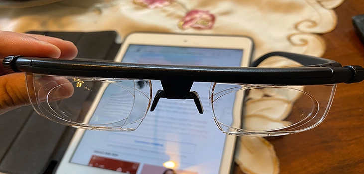 flex vision glasses holding them in front of a smartphone